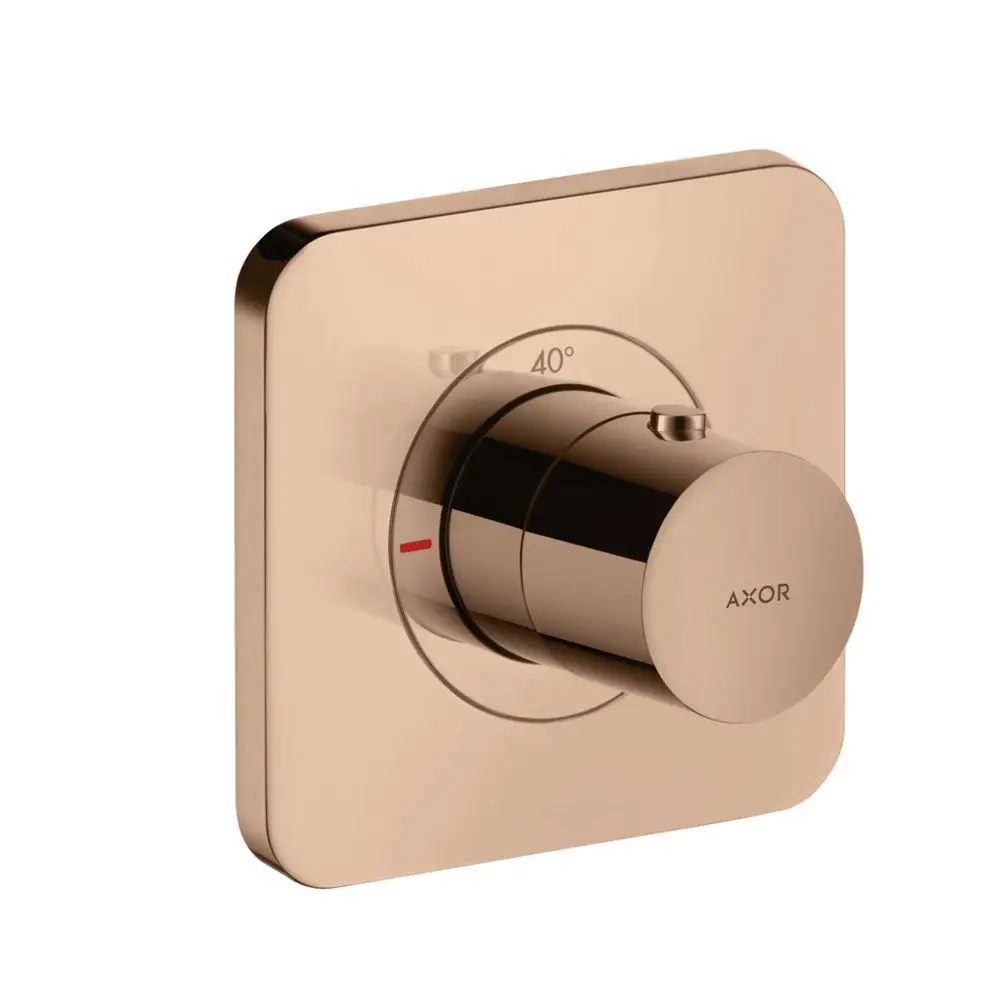 Thermostat von AXOR in poliertem Rotgold mit einem runden Regler. Die Temperatur ist auf 40° markiert, mit einer rot gekennzeichneten Bereichsanzeige.